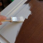 a brown kitchen cabinet is painted with white chalk paint