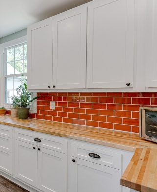 modern kitchen interior white cabinets black hardware bold orang