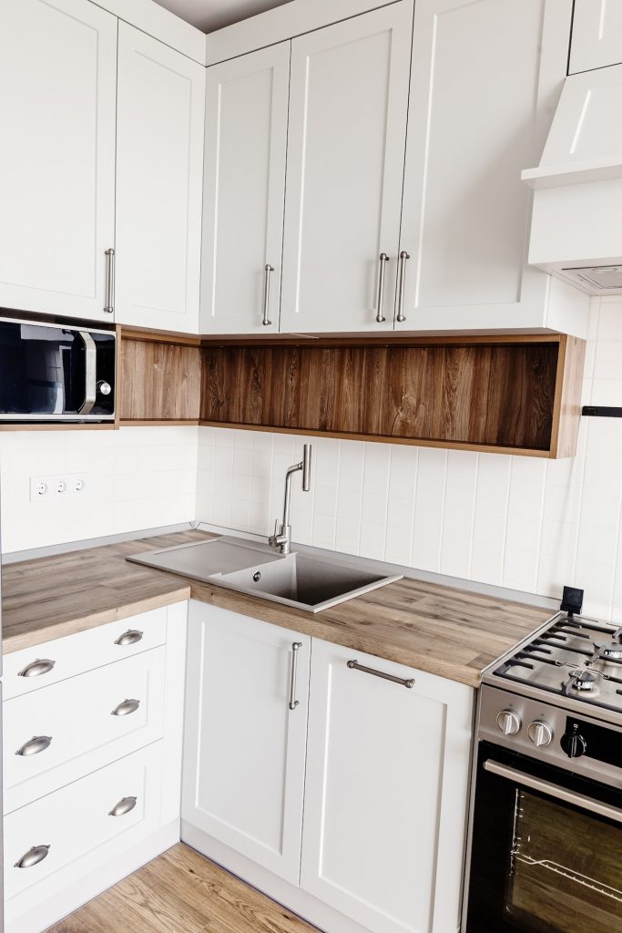 Light gray kitchen interior with modern cabinets and stainless steel appliances