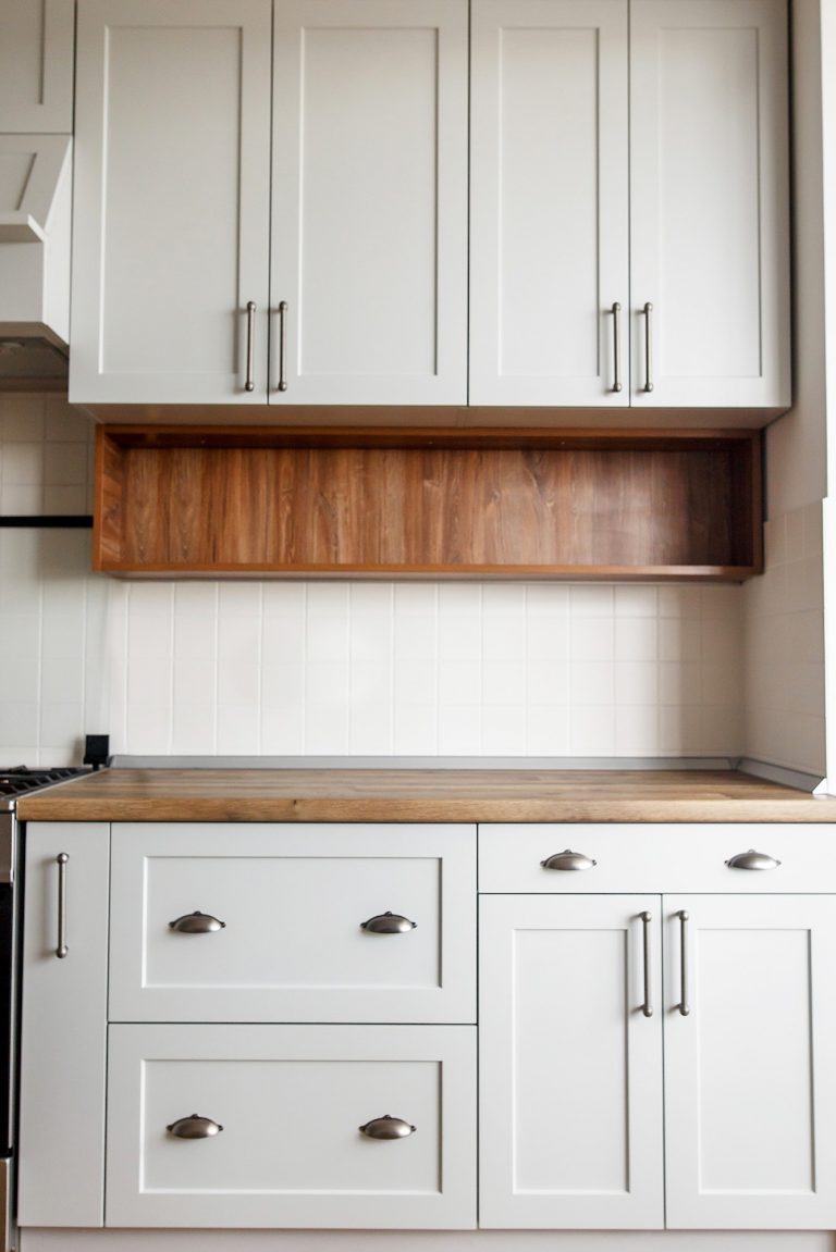 Light gray kitchen interior with modern cabinets and stainless steel appliances