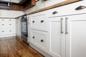 Light gray kitchen interior with modern cabinets and stainless steel appliances